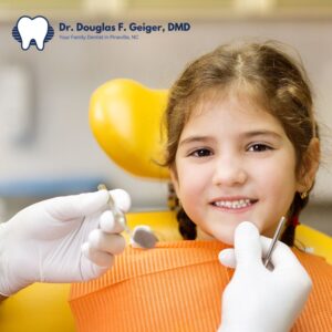 Young girl having her teeth examined at the dentist